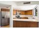 Functional kitchen featuring stainless steel appliances, wood cabinetry, and a breakfast bar at 17037 E El Pueblo Blvd, Fountain Hills, AZ 85268