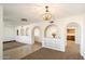 Spacious living room featuring archways, neutral paint, and views into the kitchen area, perfect for entertaining at 17037 E El Pueblo Blvd, Fountain Hills, AZ 85268