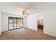 Spacious living room with plush carpet and a ceiling fan. Includes a door to a Jack-and-Jill bathroom at 17037 E El Pueblo Blvd, Fountain Hills, AZ 85268