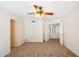 Open living room with carpet flooring and a ceiling fan. Includes doors and entryways to other rooms at 17037 E El Pueblo Blvd, Fountain Hills, AZ 85268