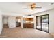 Open living area with kitchen access and sliding glass doors leading to an outdoor patio space at 17037 E El Pueblo Blvd, Fountain Hills, AZ 85268