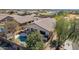 Aerial view of a home featuring private pool and patio, desert landscaping, and fenced yard at 17560 W Desert View Ln, Goodyear, AZ 85338