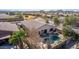 Aerial view of a charming home showcasing a private pool, lush landscaping, and a tile roof at 17560 W Desert View Ln, Goodyear, AZ 85338