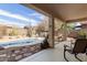 Inviting covered patio with a serene pool and desert landscaping, perfect for outdoor living and relaxation at 17560 W Desert View Ln, Goodyear, AZ 85338