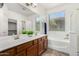 Bathroom with double sink vanity, soaking tub, and walk-in shower at 17560 W Desert View Ln, Goodyear, AZ 85338