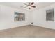 Bedroom with neutral walls, carpet, ceiling fan, and windows at 17560 W Desert View Ln, Goodyear, AZ 85338