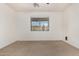 Bedroom with neutral walls, carpet, ceiling fan, and window at 17560 W Desert View Ln, Goodyear, AZ 85338