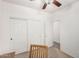 Neutral bedroom with sliding closet doors, ceiling fan and carpeted floor at 17560 W Desert View Ln, Goodyear, AZ 85338