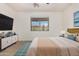 Serene bedroom featuring neutral tones, a large window, and contemporary furnishings at 17560 W Desert View Ln, Goodyear, AZ 85338