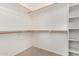 Walk-in closet with carpet, multiple shelves and hanging rods at 17560 W Desert View Ln, Goodyear, AZ 85338