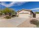 Beige single-story home with desert landscaping and two-car garage at 17560 W Desert View Ln, Goodyear, AZ 85338