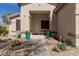 Covered front porch with desert landscaping in the front yard at 17560 W Desert View Ln, Goodyear, AZ 85338