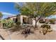 Desert landscaped front yard of single-story home with covered front porch at 17560 W Desert View Ln, Goodyear, AZ 85338