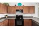 Kitchen with oak cabinets and black electric range at 17560 W Desert View Ln, Goodyear, AZ 85338