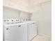 Functional laundry room featuring a washer and dryer with wire shelving for storage at 17560 W Desert View Ln, Goodyear, AZ 85338