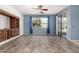 Living room featuring tile flooring, a blue accent wall and a sliding glass door at 17560 W Desert View Ln, Goodyear, AZ 85338