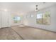 Bright living room with neutral carpet, large window and adjacent tile entry at 17560 W Desert View Ln, Goodyear, AZ 85338