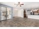 Living room featuring tile flooring and sliding glass doors, connects to kitchen at 17560 W Desert View Ln, Goodyear, AZ 85338