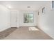 Bright living room with neutral carpet, large window and front door at 17560 W Desert View Ln, Goodyear, AZ 85338