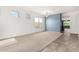 Spacious living room featuring plush carpeting and blue accent wall at 17560 W Desert View Ln, Goodyear, AZ 85338