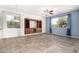 Living room featuring tile and carpet flooring and a blue accent wall at 17560 W Desert View Ln, Goodyear, AZ 85338