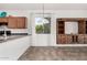 Bright living space with rustic wood cabinet, light neutral walls, and hanging light fixture over dining area at 17560 W Desert View Ln, Goodyear, AZ 85338