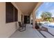 Covered patio space overlooking a private pool and outdoor seating area with mature landscaping at 17560 W Desert View Ln, Goodyear, AZ 85338