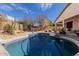 Backyard pool with desert landscaping, covered patio and blue skies at 17560 W Desert View Ln, Goodyear, AZ 85338