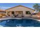 Refreshing private pool with waterfall, shaded patio, and desert-style landscaping at 17560 W Desert View Ln, Goodyear, AZ 85338