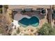 Aerial view of a private pool, with desert landscaping, and rock waterfall feature at 17560 W Desert View Ln, Goodyear, AZ 85338