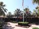 Exterior view of resident's club with flags, palm trees and beautiful landscaping at 17560 W Desert View Ln, Goodyear, AZ 85338