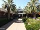 Resident's Club exterior view featuring palm trees, well-maintained landscaping and inviting entrance at 17560 W Desert View Ln, Goodyear, AZ 85338