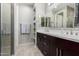 Bathroom featuring a double vanity and a separate shower at 17577 W Desert Bloom St, Goodyear, AZ 85338