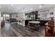 Spacious kitchen with a central island, dark wood cabinetry, stainless steel appliances, and pendant lighting at 17577 W Desert Bloom St, Goodyear, AZ 85338