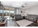 Bright living room featuring a ceiling fan, and a sliding glass door leading to the backyard at 17577 W Desert Bloom St, Goodyear, AZ 85338