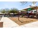 A colorful playground with slides and swings offers a recreational space at 17577 W Desert Bloom St, Goodyear, AZ 85338