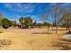 A picturesque, vacant volleyball court surrounded by trees and open fields at 17577 W Desert Bloom St, Goodyear, AZ 85338