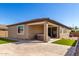 Rear exterior view of the house showing outdoor seating, patio, and artificial turf at 17588 W Maricopa St, Goodyear, AZ 85338