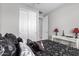 Bright bedroom featuring a black themed bedding, natural lighting, and ample space at 17588 W Maricopa St, Goodyear, AZ 85338