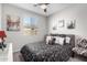 Bedroom with a ceiling fan, decor, and large window at 17588 W Maricopa St, Goodyear, AZ 85338