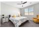 Bright bedroom featuring neutral walls, plush carpeting, and a ceiling fan for added comfort at 17588 W Maricopa St, Goodyear, AZ 85338