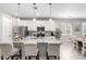 Bright kitchen featuring a granite island with seating, stainless appliances, and white cabinetry at 17588 W Maricopa St, Goodyear, AZ 85338