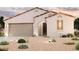 Charming single-story home with a two-car garage, a neutral color palette, and a well-manicured desert landscape at 1902 S 246Th Ln, Buckeye, AZ 85326