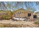 Inviting backyard with a covered patio and a lush palm tree, ideal for relaxing and enjoying the outdoors at 19595 N 107Th Dr, Sun City, AZ 85373