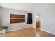 Neutral bedroom with wood floors and decorative wood panel wall decorations at 19595 N 107Th Dr, Sun City, AZ 85373