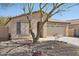 Charming single-story home with desert landscaping, mature tree, and inviting curb appeal at 19595 N 107Th Dr, Sun City, AZ 85373