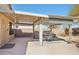 Covered patio space with outdoor furniture and a built-in BBQ grill, perfect for entertaining and relaxing outdoors at 19595 N 107Th Dr, Sun City, AZ 85373