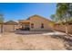 Exterior view of the home's backyard, with a custom fountain feature, patio, and open area at 2106 E 39Th Ave, Apache Junction, AZ 85119