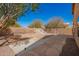 Backyard with a custom fountain feature and stone tile landscaping at 2106 E 39Th Ave, Apache Junction, AZ 85119