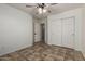 Bright bedroom featuring a ceiling fan, tile flooring, and a double door closet for easy storage at 2106 E 39Th Ave, Apache Junction, AZ 85119